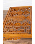 Brown elmwood square coffee table with open fretwork and horse-hoof legs on a wood floor indoors.