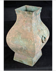 Weathered bronze Hu vessel with square opening, square base, and round side handle, Chinese Han Dynasty.