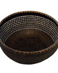 Brown lacquered bamboo basket with round shape, open lattice design, and solid base on white background.