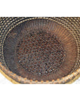 Red Chinese lacquered bamboo basket with intricate pattern on base and sides, top view, empty.