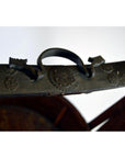 Close-up of silver metal handle with floral engravings on Chinese wedding basket, ornate detail visible.