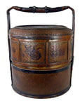 Large brown Chinese wedding basket with lid and handle, decorative sides, woven material, close-up view.