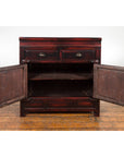 Brown wood Late Qing Dynasty 1900s side cabinet with two drawers, open doors, and shelves on a wood floor.