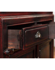 Close-up of a reddish black lacquered wood Chinese Late Qing Dynasty side cabinet with one open drawer.