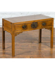 Brown elm Chinese Late Qing Dynasty desk with two drawers and ornate brass hardware on wood floor by white brick wall.