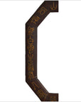 Close-up of dark wood octagonal Chinese leather frame with gold calligraphy carved along the edge.