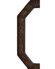 Close-up of dark wood octagonal Chinese leather frame with gold calligraphy carved along the edge.