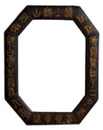 Close-up of octagonal dark wood Chinese leather frame with gold calligraphy on white background.