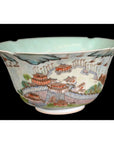 Black porcelain bowl with colorful city scenes and traditional Chinese buildings, close-up.
