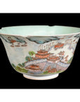 Close-up of a red, green, and blue Chinese Mankok porcelain bowl with ancient architecture and landscape designs.