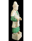 Green-and-white glazed ceramic Ming Dynasty figure on rectangular base, close-up view.