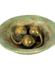 Close-up of three spherical objects with curved stems in a Chinese Ming Dynasty food plate, antique style.