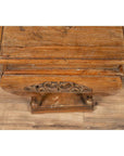 Brown wooden incense stand with cabriole legs and carved apron on rustic wooden floor.