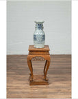 Blue and white ceramic vase on Chinese Ming style incense stand with cabriole legs and carved apron.