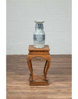 Blue and white ceramic vase on Chinese Ming style incense stand with cabriole legs and carved apron.