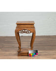Brown wooden Ming style incense stand with cabriole legs and carved apron on wooden floor, chart in front.