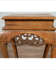 Brown wooden incense stand with cabriole legs and carved apron, rustic finish, Ming style, photographed indoors.