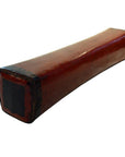 Rectangular red lacquered Chinese opium pillow with black ends on a white background.