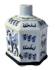Close-up of vintage hexagonal blue and white painted ceramic bottle with short neck, covered, cloud and figure patterns.