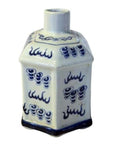 Close-up of blue and white painted ceramic bottle with covered top, short cylindrical neck, and intricate patterns.