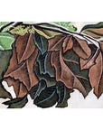 Green and brown leaves, some curled and dry, on silk fabric with a light background.