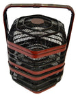 Close-up of black and red hexagonal Chinese picnic basket with three stacked tiers and large top handle.