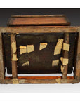 Brown and beige wooden Chinese picnic box, reinforced with masking tape and wooden supports, bottom view.