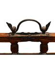 Close-up of rustic metal handle with vintage decorative accents on wood, Chinese picnic box detail.