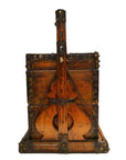 Brown wood and metal Chinese picnic box with iron reinforcements, shaped like a stringed instrument, close-up view.