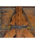 Close-up of a brown wooden Chinese picnic box with metal accents and carved details, showing aged patina.