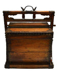 Brown wood and metal Chinese picnic box with handle and ornate front detailing, used for sewing or storage.