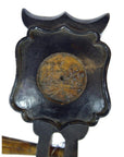 Close-up of a wooden Chinese PiPa lute with carved back and visible fret damage.