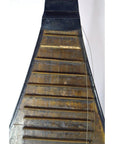 Close-up of a brown wooden Chinese PiPa lute with a damaged fret and loose wire string.