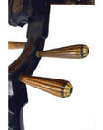 Close-up of three wooden pegs on a damaged wooden pegbox of a used Chinese PiPa Lute, set on a dark curved surface.