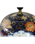 Close-up of a dark blue Chinese porcelain electric lamp with gold, orange, and cream floral patterns.