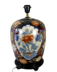 Red, blue, and gold floral Chinese porcelain electric lamp on black stand, shown in good condition.