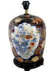 Blue, red, and gold floral Chinese porcelain electric lamp on dark base, in good condition, close-up view.