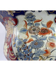 Close-up of a blue, red, gold, and cream Chinese porcelain planter with hand-painted floral patterns.