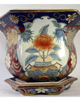 Multicolor Chinese porcelain planter with hand-painted floral patterns and large central flower, close-up view.