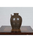 Glazed ceramic water jug with petite spout, Chinese Qing Dynasty, 19th century, on wooden table.