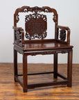 Dark rosewood Chinese chair with hand-carved details, 19th century, displayed on a wooden floor.