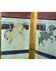 Spotted and gray hand painted horse figurines in arena setting, Chinese screen in background.