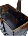 Close-up of a red wooden Chinese Shandong wedding box with decorative metal hinges and handle, empty inside.