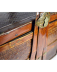 Close-up of a red wood Chinese Shandong wedding box with rattan panels and decorative brass lock.