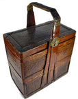 Brown bamboo and rattan rectangular wedding box with hinged handle and metal latch, close-up.