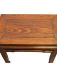 Brown wooden rectangular Chinese side table with simple design, small green sticker on top corner, top view.