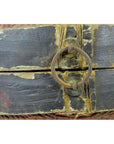 Close-up of weathered metal ring handle on painted wood Chinese storage basket with rattan twine detailing.