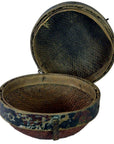 Brown rattan Chinese storage basket with hinged lid, textured interior, and worn exterior, close-up view.