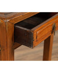 Close-up of brown elmwood table with open single drawer and cracked ice shelf, vintage Chinese style.