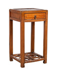 Brown elmwood lamp table with single drawer and cracked ice shelf at bottom, vintage style, indoor setting.